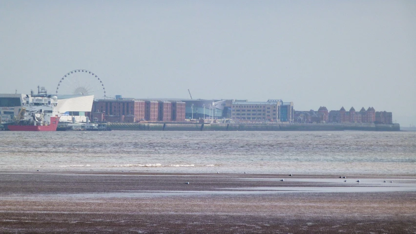 a large barge is on the water near buildings