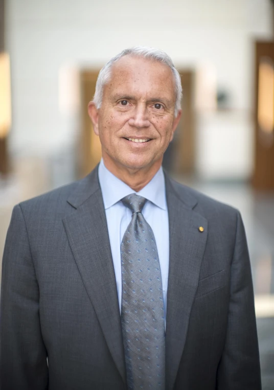 a man in suit and tie posing for a picture