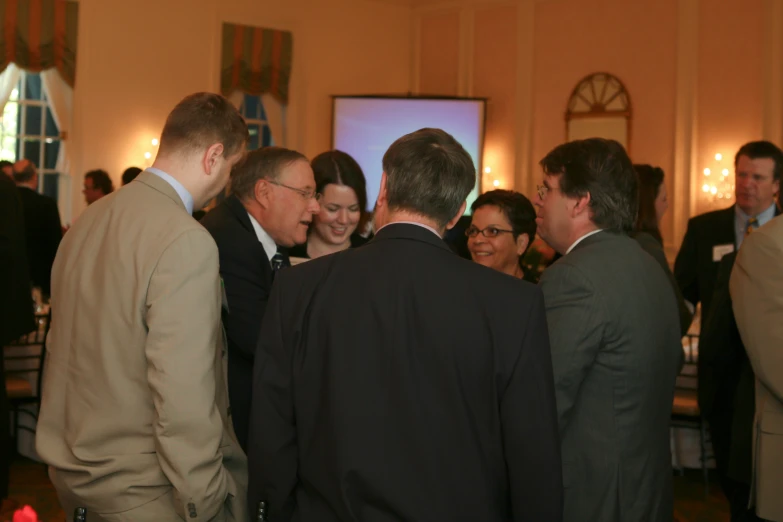 a group of people standing around each other near one another