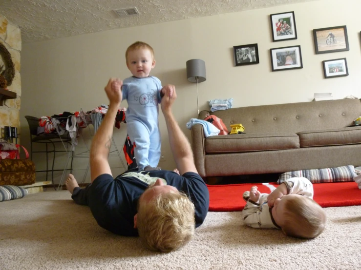 an image of a man playing with a baby