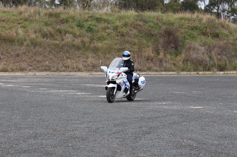 a person is riding on a white and blue motorcycle