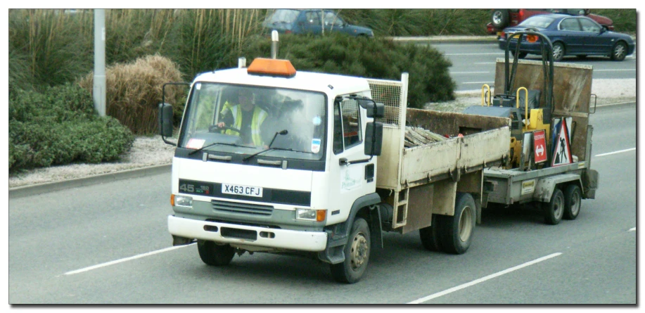 the utility truck is driving in a lane