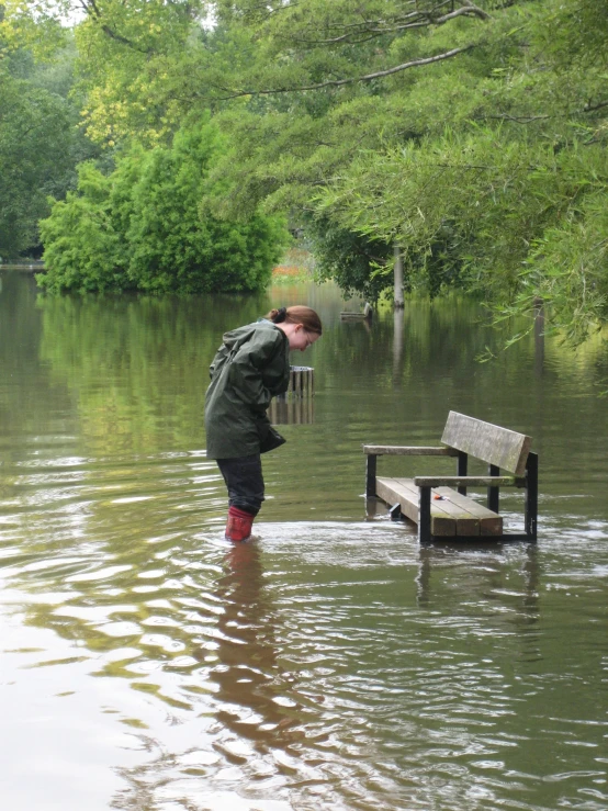 a man with red boots standing on a boat ramp near a lake