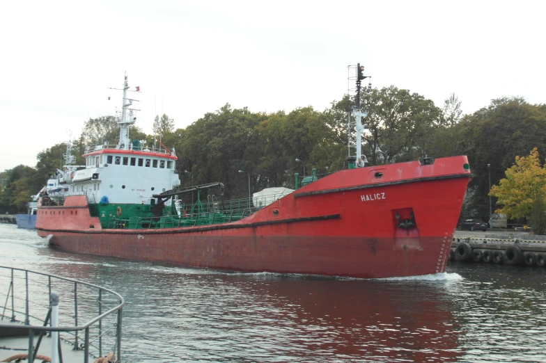 an image of a red boat going by the dock