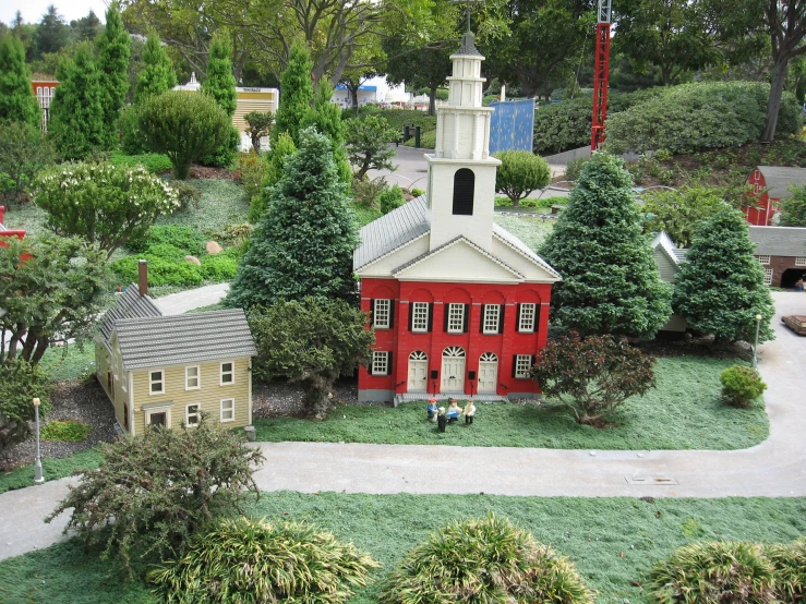 a miniature train display of houses, trees and cars