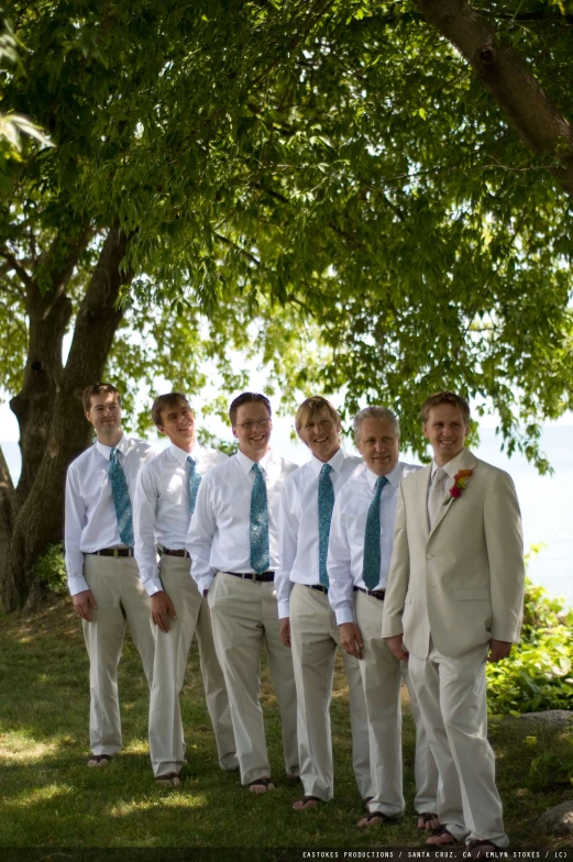 a group of people standing in front of a tree