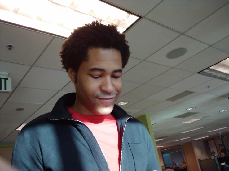 a young man looking at his phone in an office building