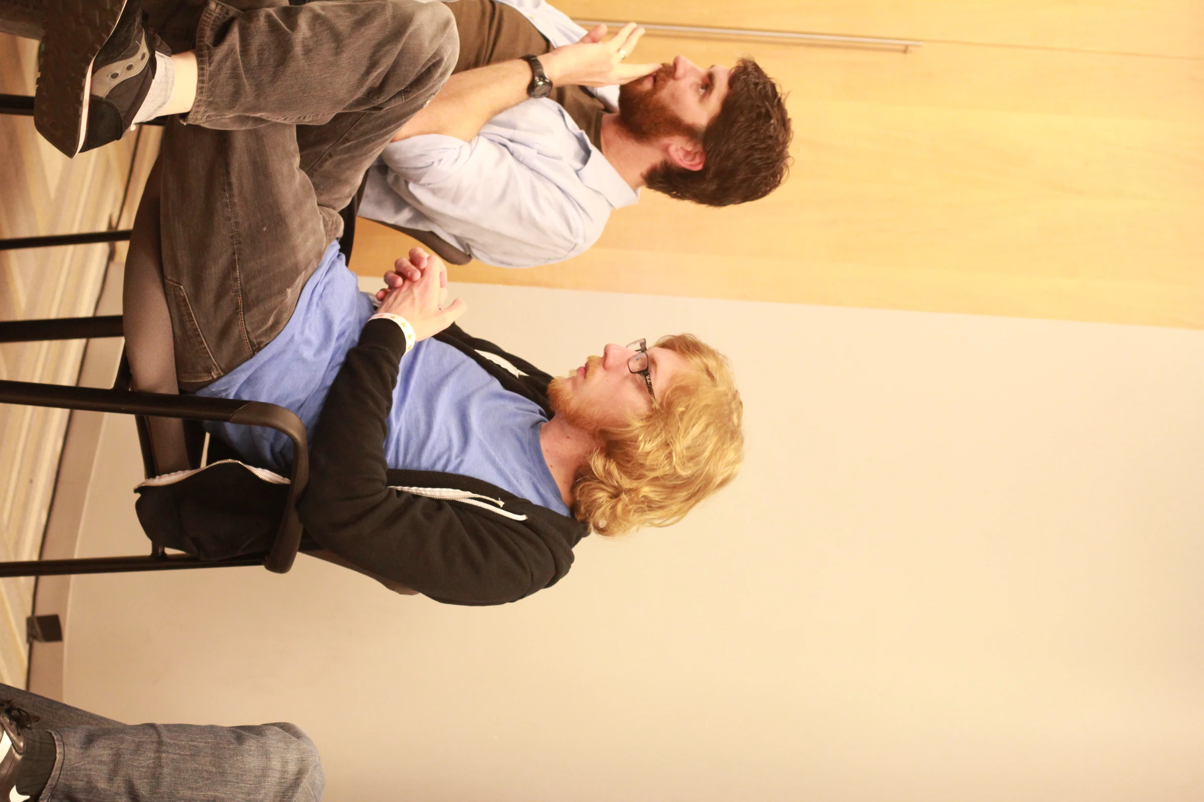 a man and woman sitting down together in chairs