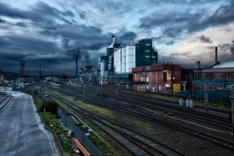 dark and cloudy sky with buildings along a train track
