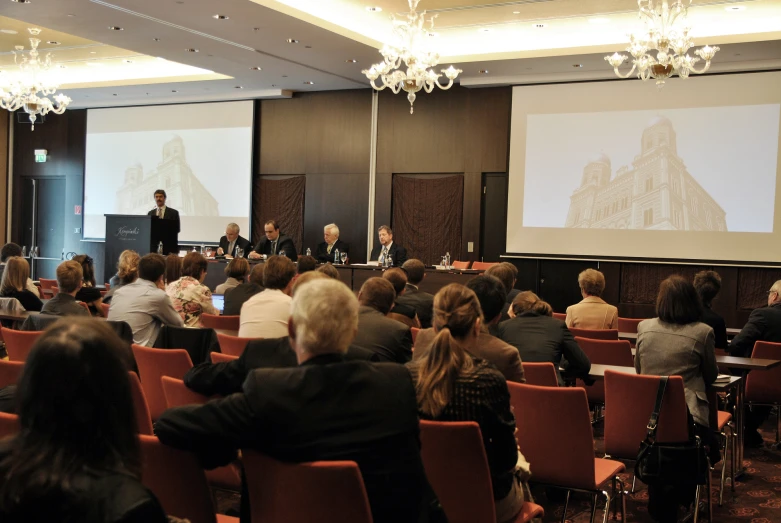 people are in front of an audience at a conference