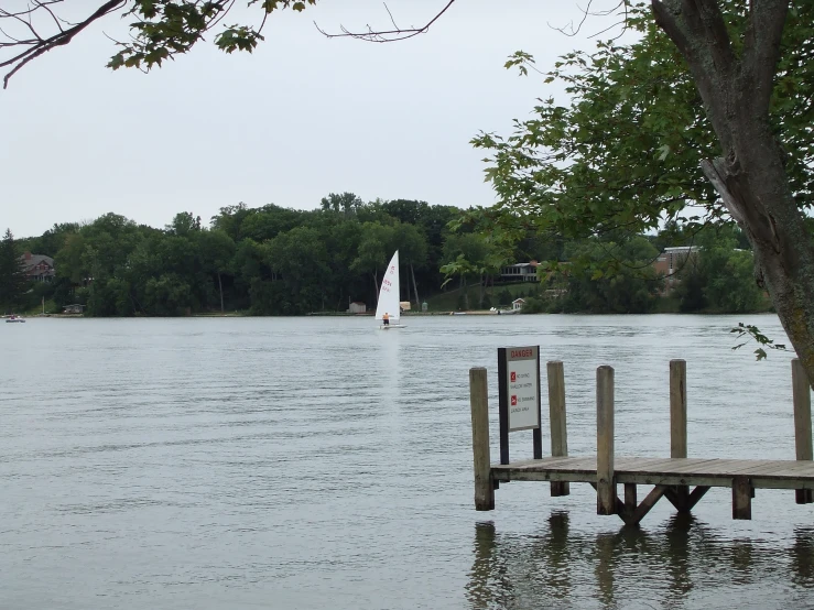 a sail boat is on the water in the distance