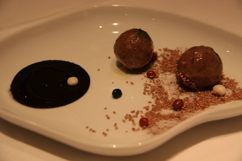 two chocolates sitting on top of a white plate