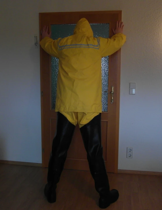 a person dressed up in yellow and black standing up