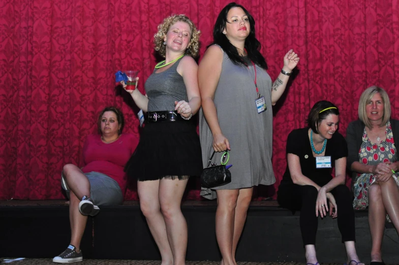 several women standing in a line and waving