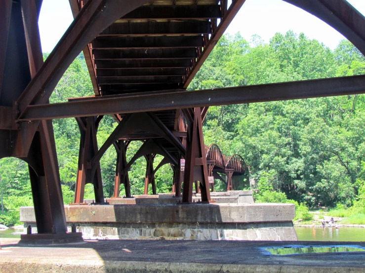 the bottom of a wooden bridge is seen in the background