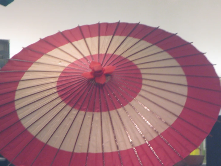 the bottom half of a pink and white umbrella