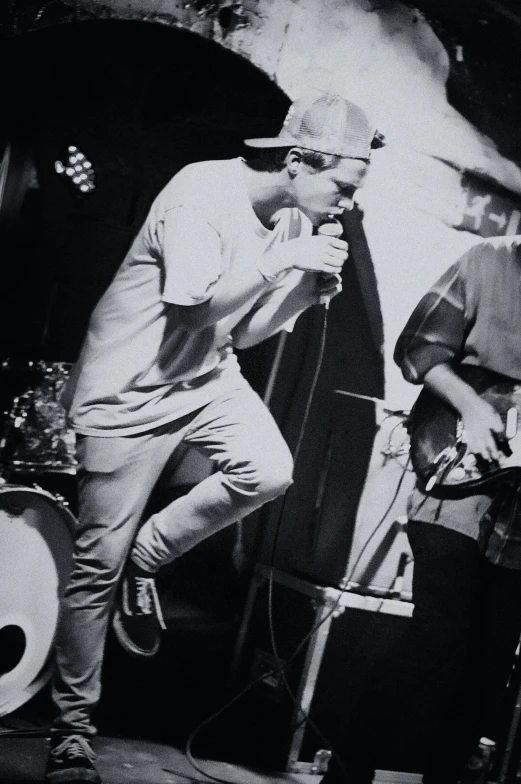 some men on stage playing instruments in black and white