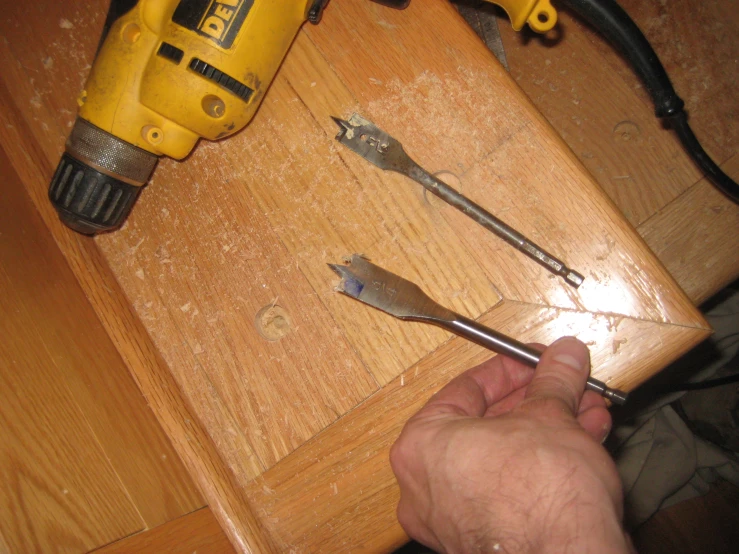 a pair of pliers and a drill on the table