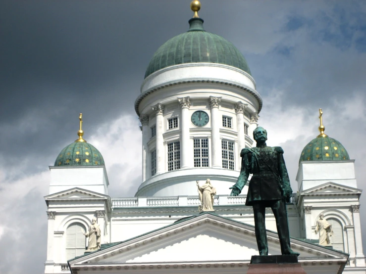 a statue standing in front of the domed building