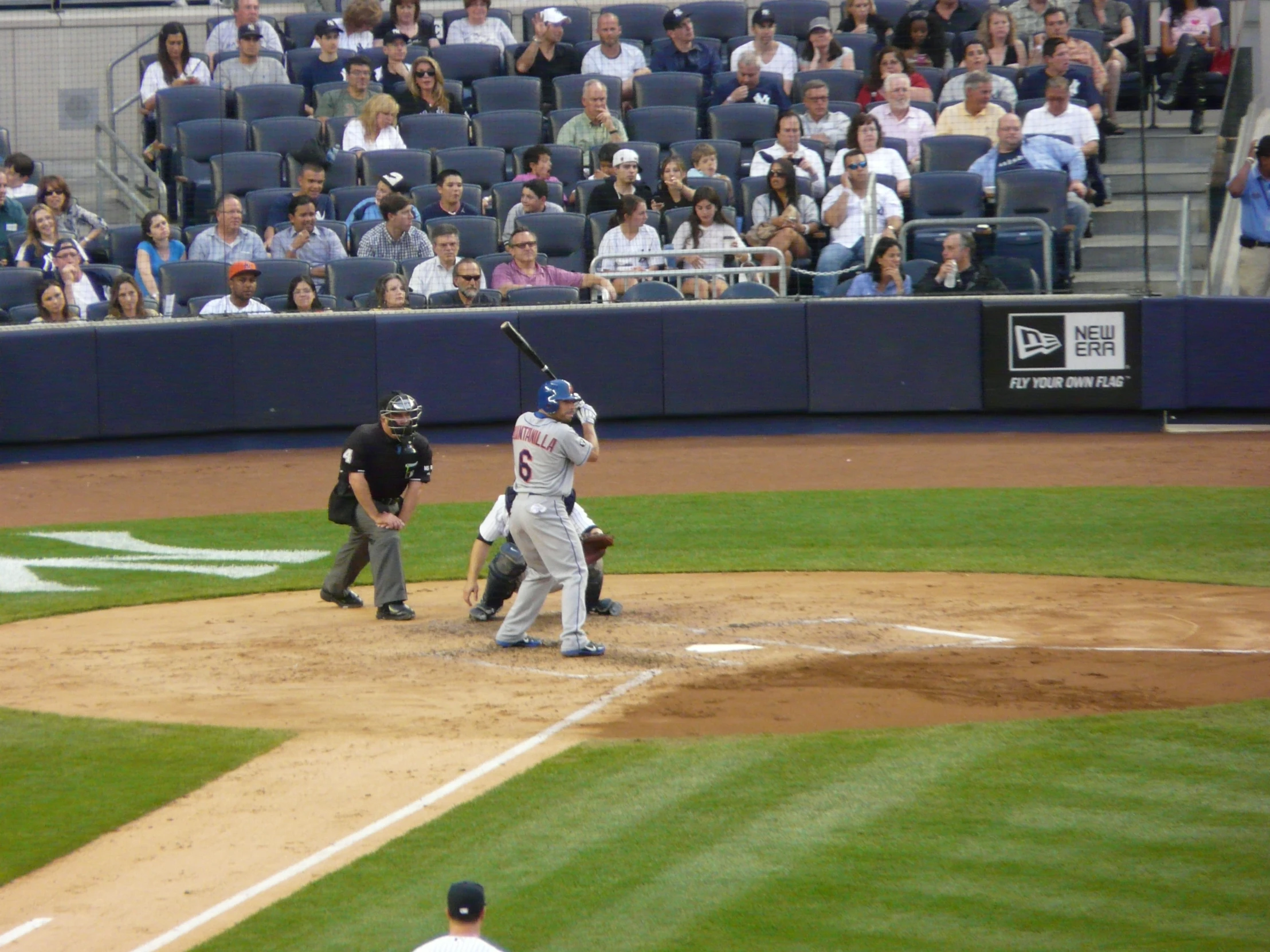 a baseball player holding a bat next to home plate