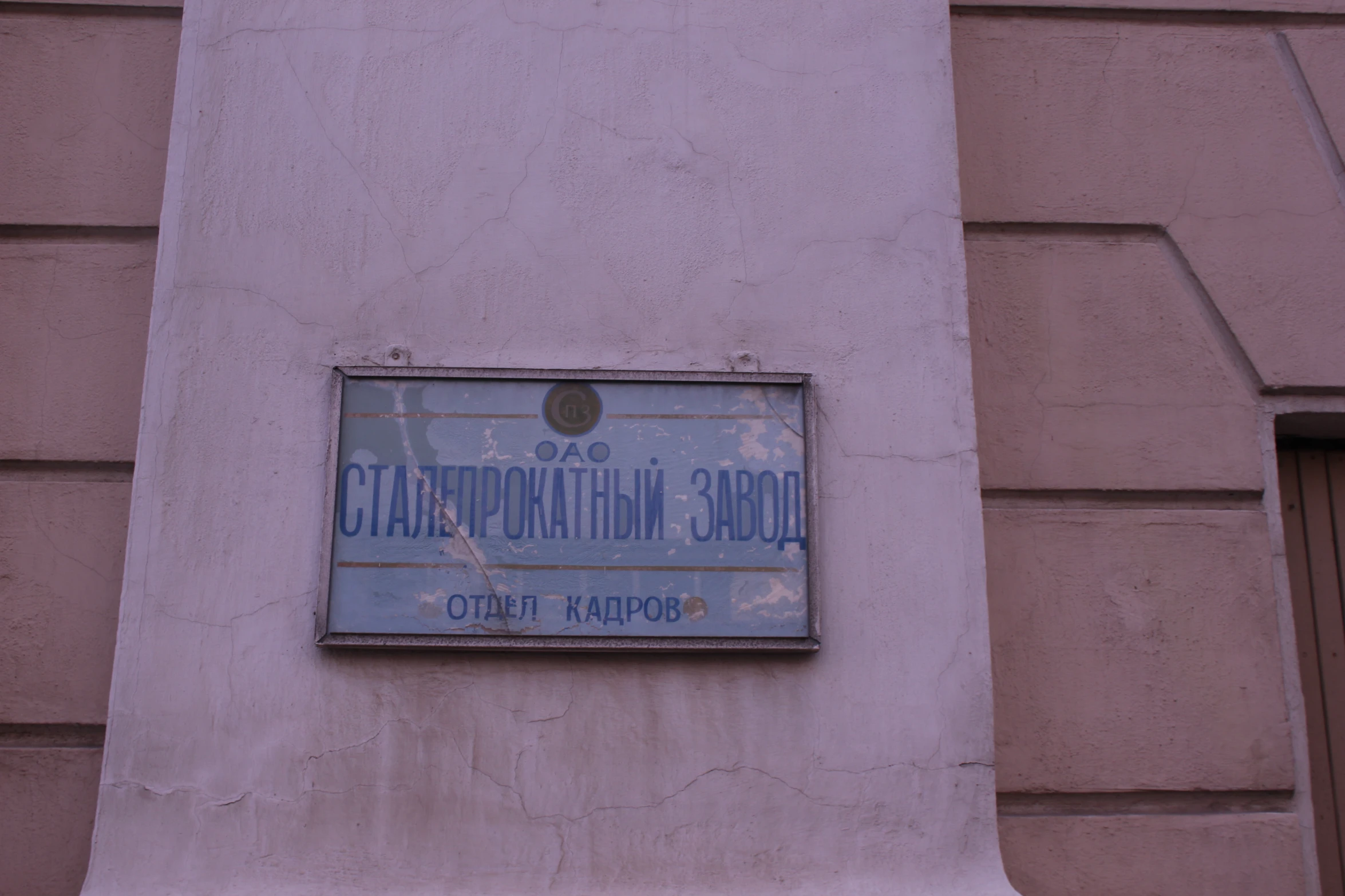 a blue street sign sitting above the side of a building