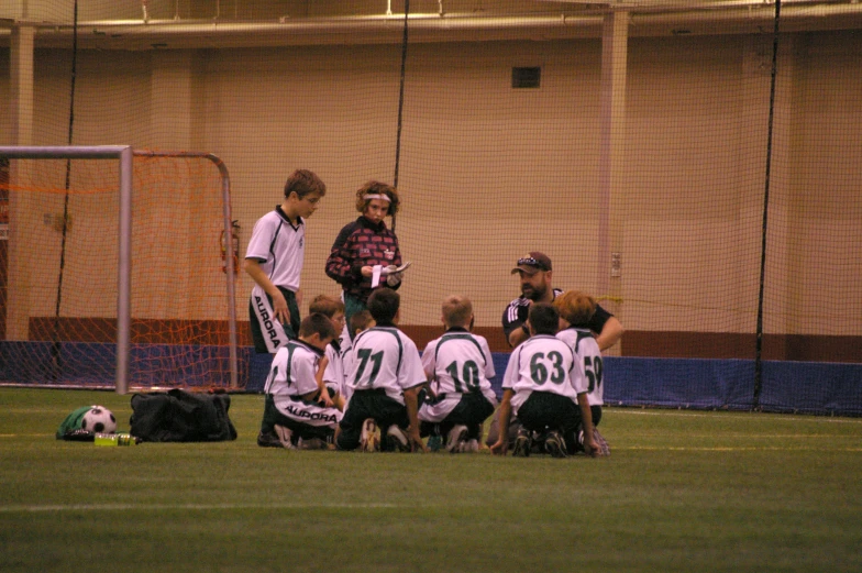 several young people standing in a group during a soccer game