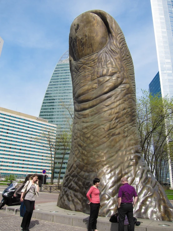 two women standing in front of a large, very tall elephant