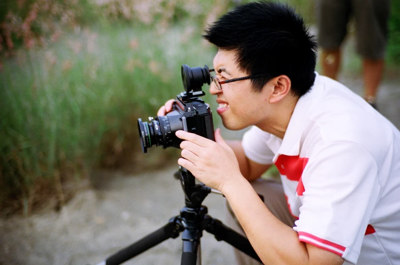 a man sitting in front of a camera taking pictures