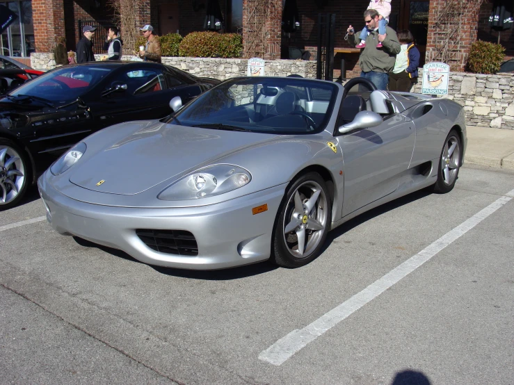 a car is parked in a parking lot next to a building