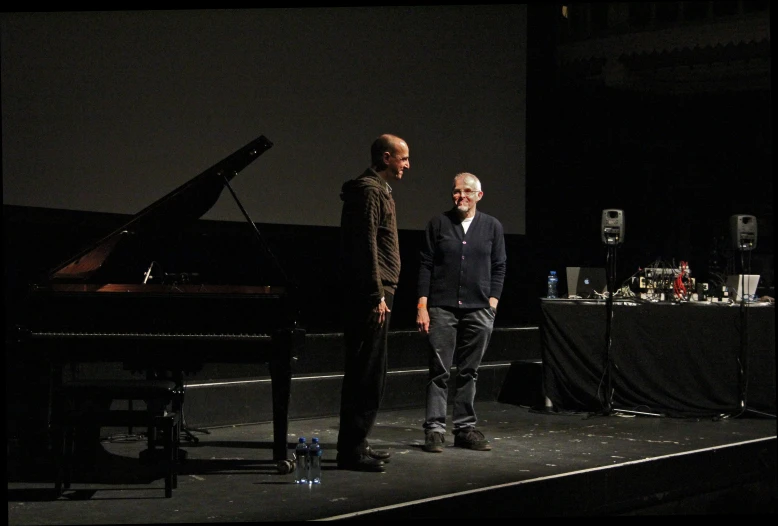 two people on a stage talking to each other