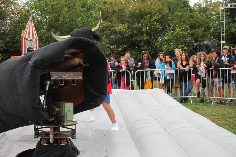 a camera on a tripod with a giant bull in it