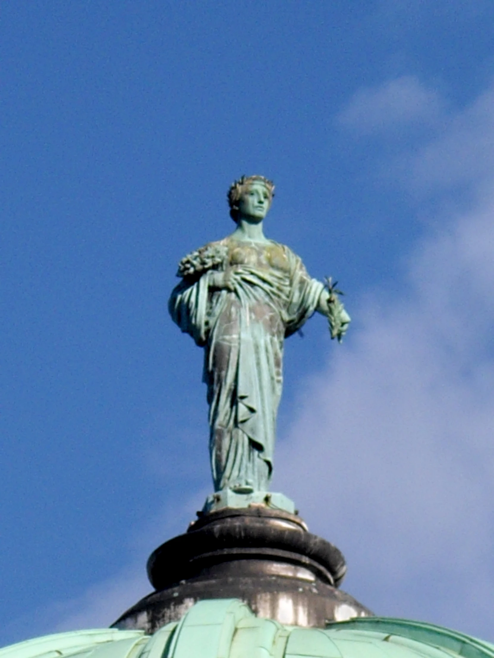 a statue of liberty atop the dome of a building