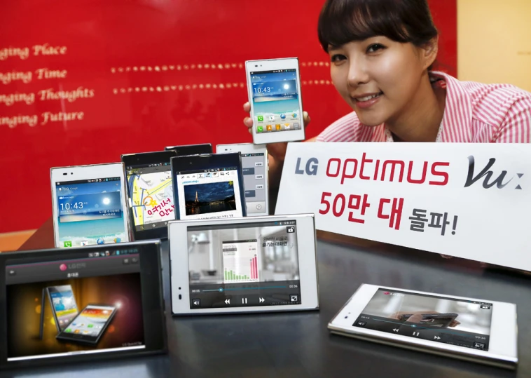 a woman with a bunch of cell phones sitting beside her