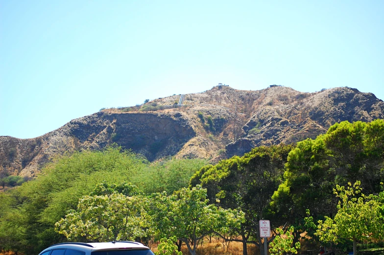 the mountains are seen behind this street sign