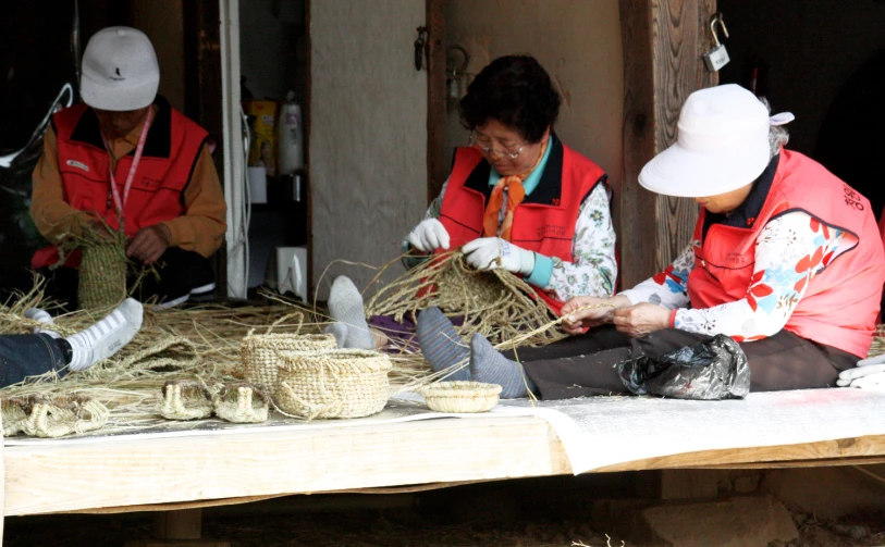 three people who are working together on a table