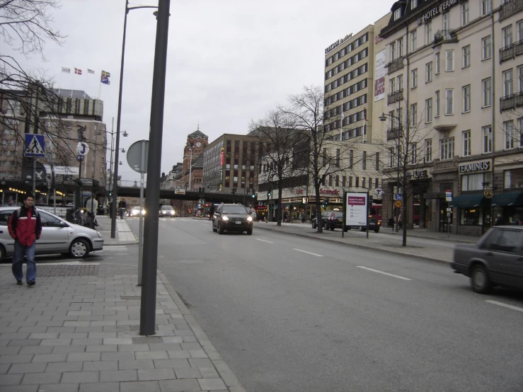 cars driving down the road in a town