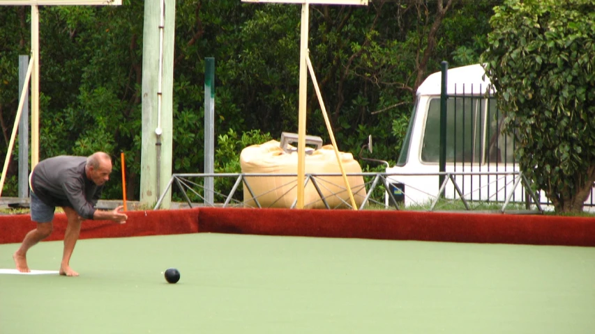 a man playing tennis on an outdoor court