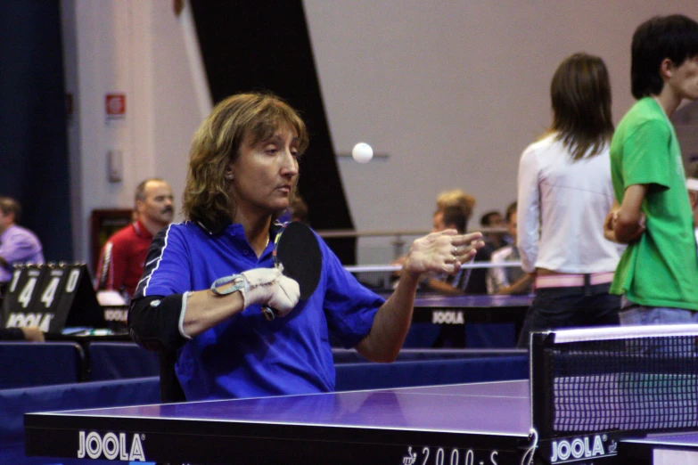 a man standing next to a ping pong table on a ping pong table