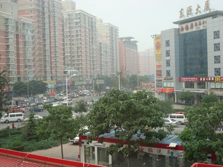 a road with many cars, buildings and trees