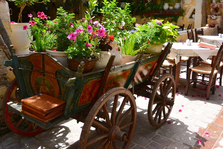 a wagon full of plants and flowers near a table
