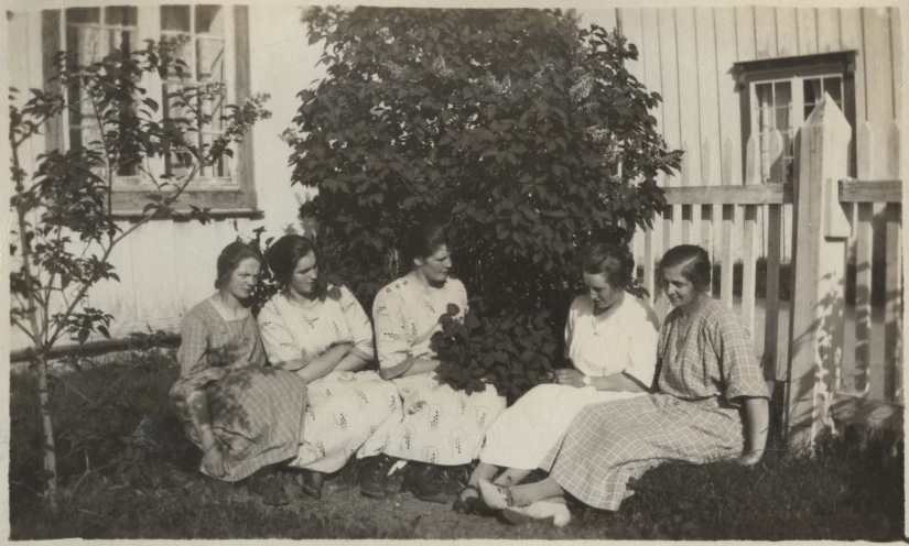 black and white pograph of women on porch with dog