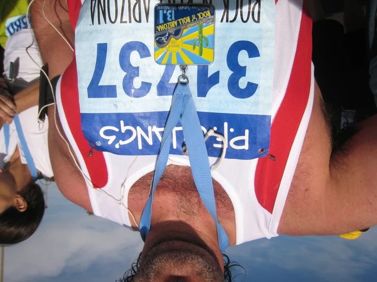 a man in a race shirt wears a blue and white tie