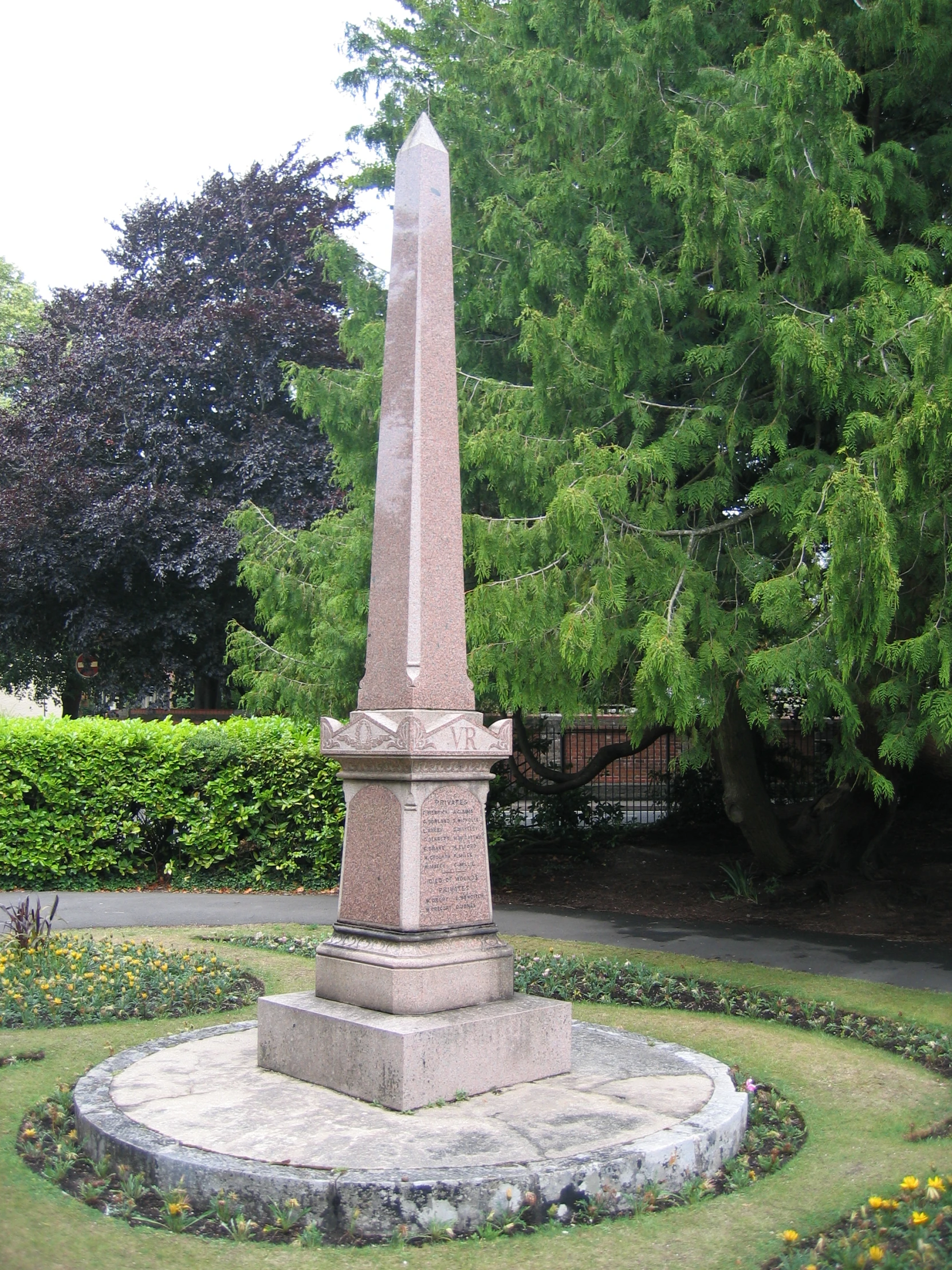 an obelisk surrounded by small circular beds of greenery