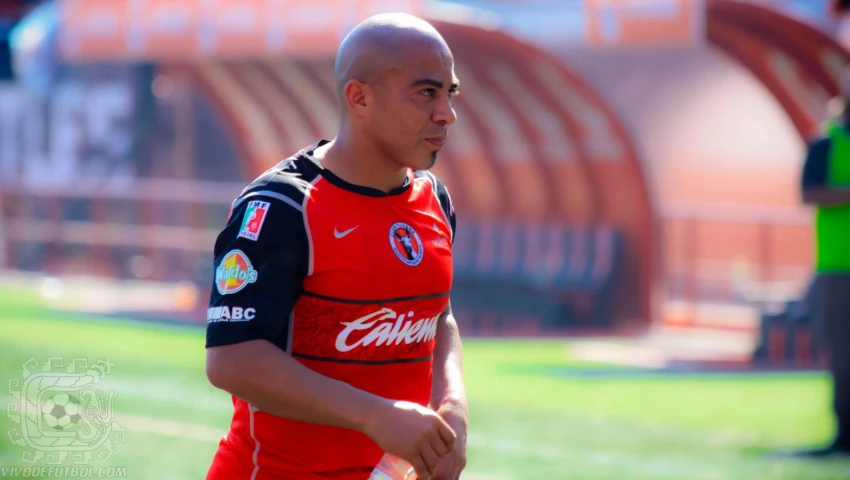 a man in red soccer uniform holding a ball