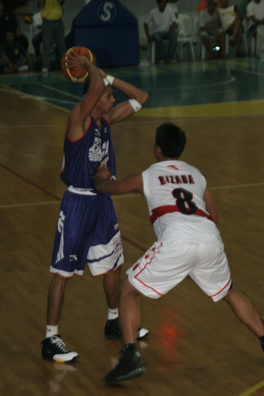 two men are trying to block the ball from another player