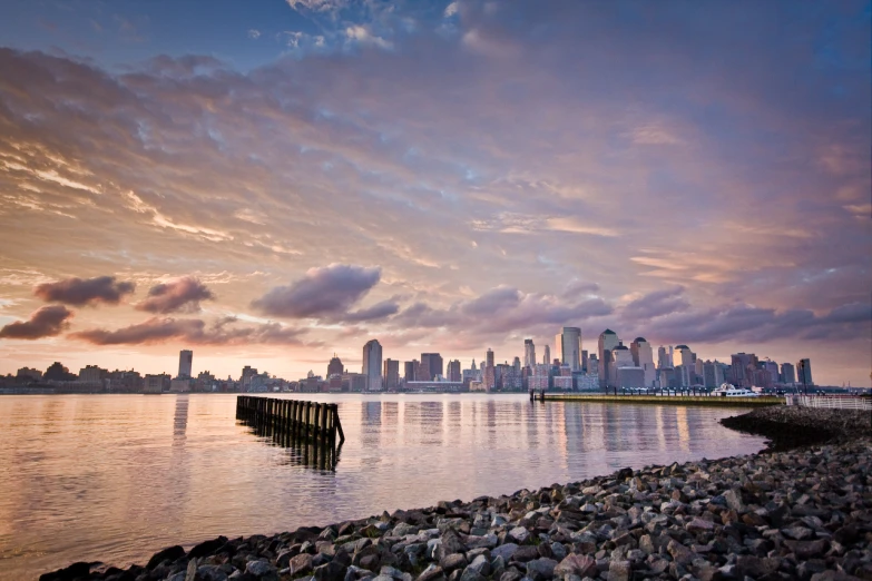 the skyline of a city rises above the bay