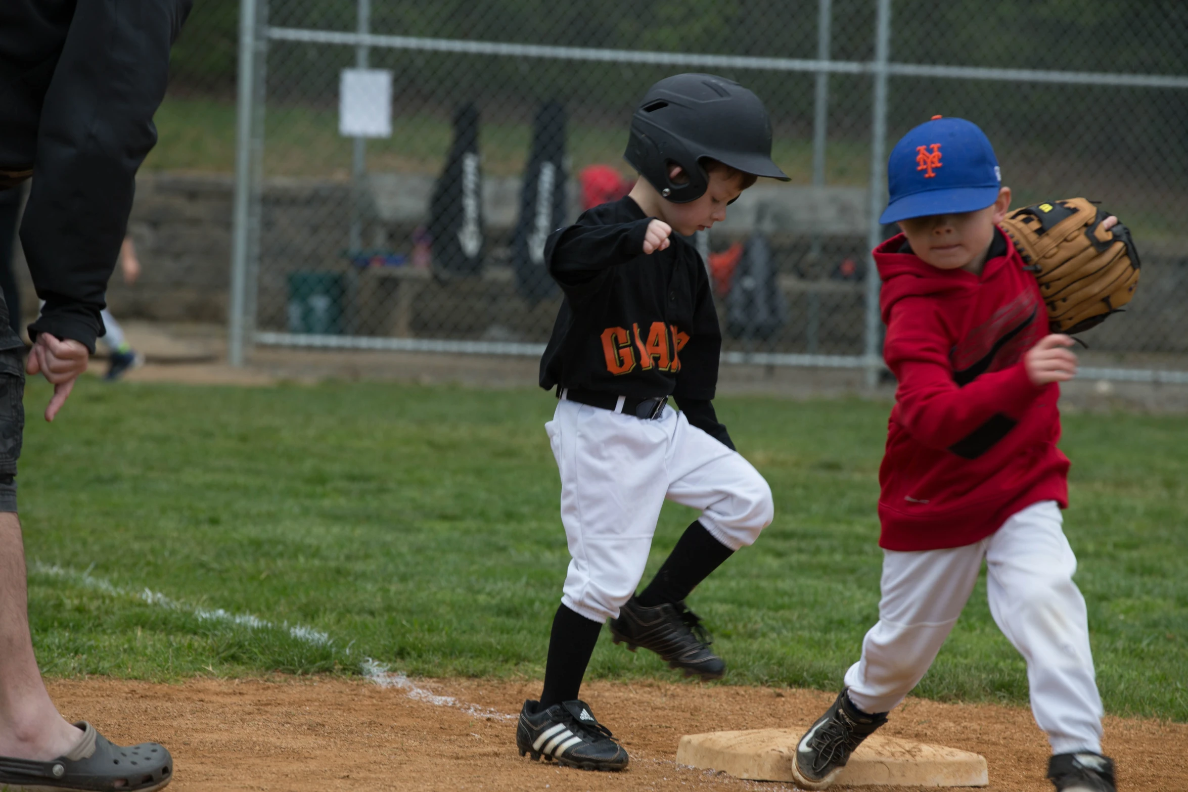 a group of children play baseball on a field