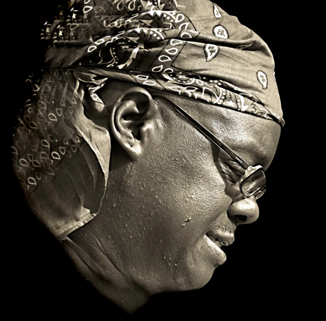 a man wearing a bandana with a ponytail and eyeglasses