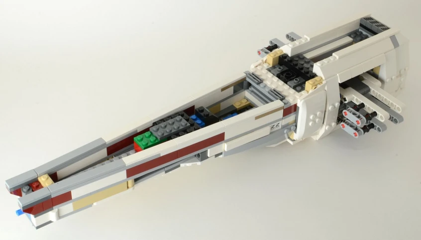 lego boat sitting on top of a white surface