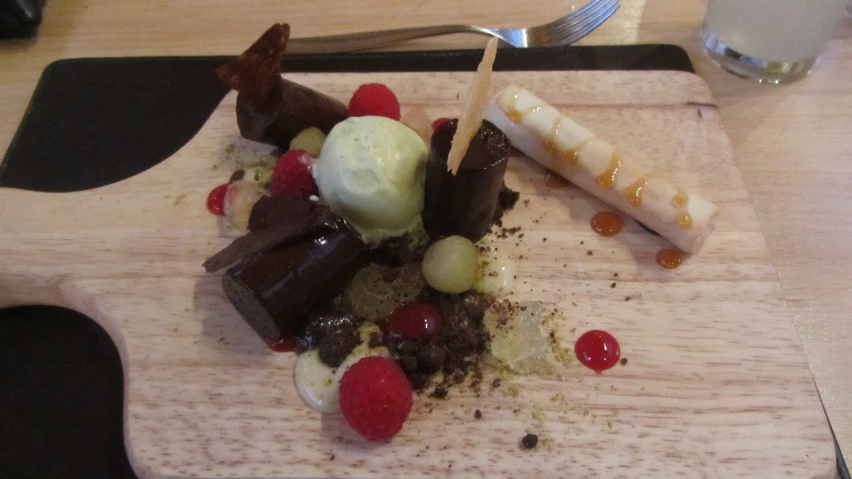 a wood  board topped with dessert items